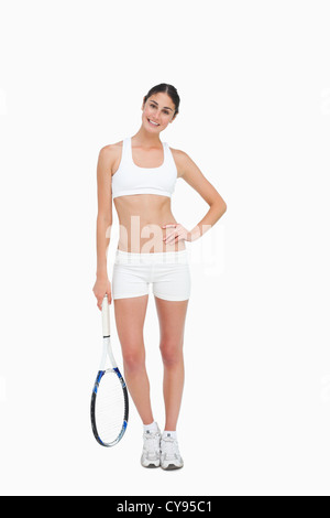 Slim brunette in posa con una racchetta da tennis Foto Stock