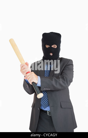 Imprenditore sorridente in un passamontagna con una mazza da baseball Foto Stock