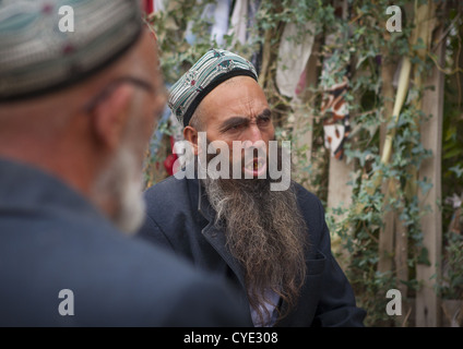 Sufi uigura uomini pregare presso l Imam Asim tomba nel deserto Taklamakan, Xinjiang Uyghur Regione autonoma, Cina Foto Stock