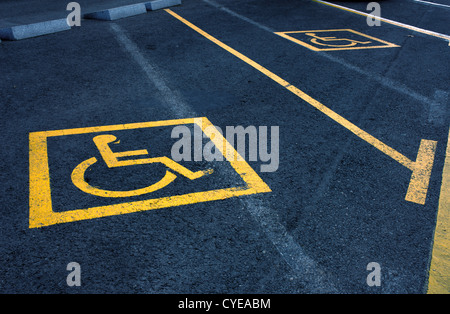 Cartelli gialli di aree di parcheggio riservato per disabili. Foto Stock