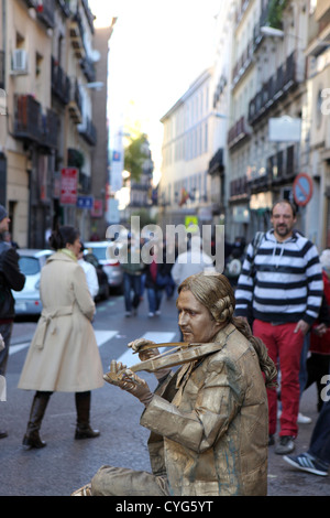 Oro Uomo dipinto statua vivente street intrattenitore, musicista classico in posa con violino, Madrid, Spagna Foto Stock