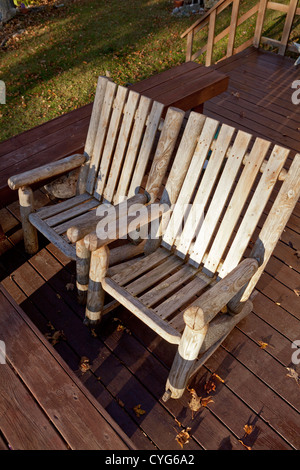Vuoto due sedie a dondolo siedono fianco a fianco su un ponte. Foto Stock
