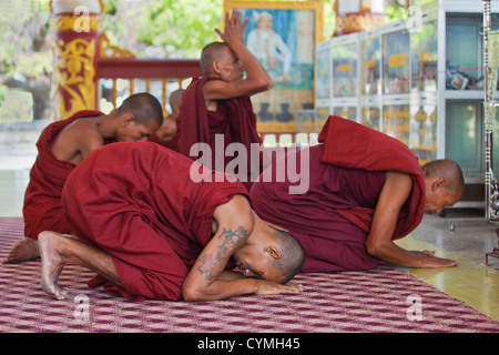 I MONACI in preghiera al KUTHODAW PAYA che ospita 729 di lastre di marmo dei Tripitaka - Mandalay, MYANMAR Foto Stock