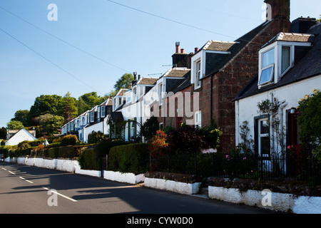 Vista di una fila di case a fianco della strada nel villaggio costiero di Corrie, Isle of Arran, Scotland, Regno Unito Foto Stock