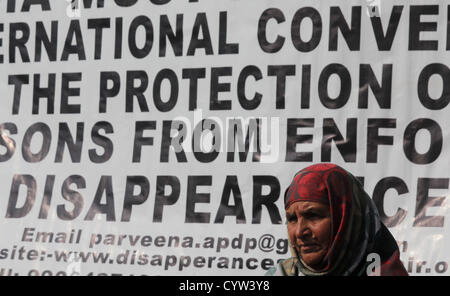 Nov. 10, 2012 - Srinagar Kashmir, India - Una madre di mancante della gioventù del Kashmir si siede di fronte a un banner come lei partecipa a una manifestazione di protesta organizzata dalla Associazione dei Genitori di Persone scomparse (APDP) a Srinagar, la capitale estiva del Kashmir indiano. Secondo APDP alcuni 8,000-10.000 persone sono scomparse dall'inizio del conflitto del Kashmir nel 1989, dopo essere stato arrestato dalle forze di sicurezza indiane e di altre agenzie di sicurezza. (Credito Immagine: © Altaf Zargar/ZUMAPRESS.com) Foto Stock