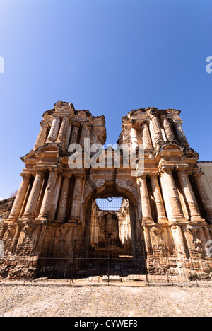 ANTIGUA GUATEMALA, Guatemala - le rovine devastate dal terremoto dell'ex Iglesia del Carmen sono una testimonianza toccante della storia sismica di Antigua Guatemala. Questo residuo di architettura coloniale spagnola, con la sua facciata barocca ornata ancora parzialmente intatta, esemplifica lo status della città come patrimonio dell'umanità dell'UNESCO. Adagiate su uno sfondo di strade acciottolate e di vulcani lontani, le rovine offrono uno scorcio sulla ricca eredità storica e architettonica dell'ex capitale. Foto Stock