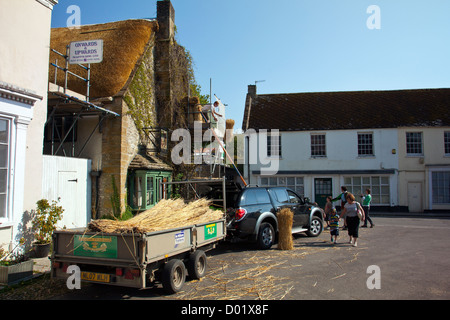 Un maestro thatcher a lavorare sul tetto della Royal Oak pub di Cerne Abbas, Dorset, England, Regno Unito Foto Stock