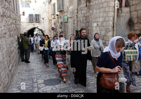 Un gruppo di pellegrini cristiani a piedi lungo la Via Dolorosa street ritiene essere il cammino che Gesù camminava sulla strada per la sua crocifissione nella città vecchia. Gerusalemme Est, Israele Foto Stock