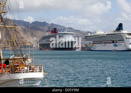 Cunard crociera Queen Mary 2 ancorata a Tenerife nelle isole Canarie. La poppa del Sorlandet, un norvegese Tall Ship. Foto Stock