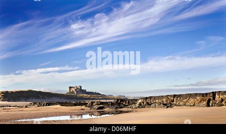 Camminare sulla spiaggia al di sotto del castello di bamborough. northumberland Foto Stock