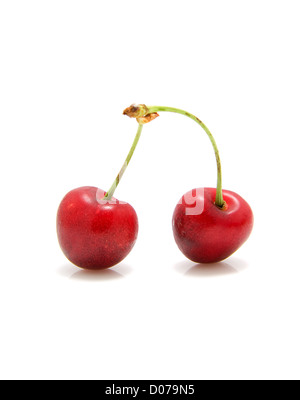 Two fresh red cherries over white background Foto Stock