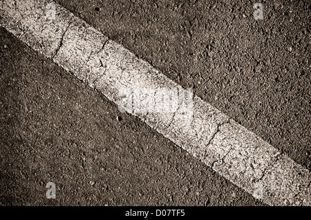 Strada asfaltata con diagonale bianca a strisce di linea Foto Stock