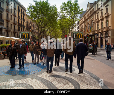 I turisti a piedi nella Ramblas una famosa strada nel centro della città di Barcellona Catalonia Spagna Foto Stock