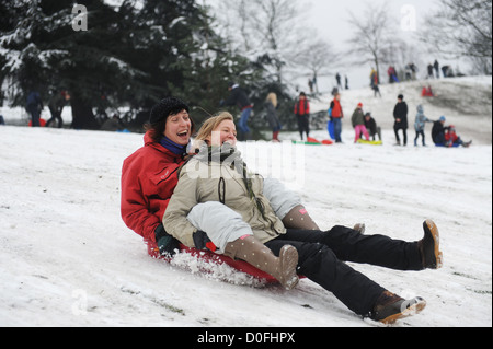 Amici in slittino Greenwich Park Londra Uk nel 2012 Foto Stock