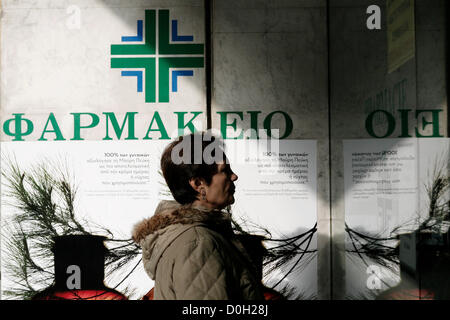 Salonicco, Grecia. Novembre 26, 2012. Una donna prendere uno sguardo alla finestra della farmacia. 48 ore di sciopero da farmacie in tutto il paese e si fermano contemporaneamente somministrare farmaci sul credito ai membri dei servizi sanitari nazionali (EOPYY) chi dovrà pagare di tasca propria e la rivendicazione l'importo del fondo. Foto Stock