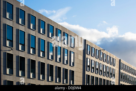 Architettura di cemento con finestre che riflette il blu del cielo di Copenhagen, Danimarca. Foto Stock