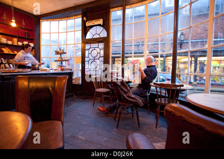 Un uomo si rilassa in farmacia cafe di segale. Foto Stock