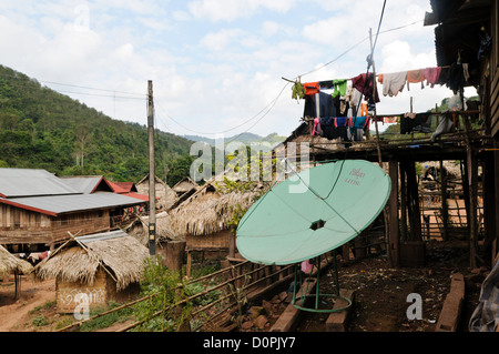 LUANG NAMTHA, Laos - Il ponte di una casa nel villaggio Lakkhamma a Luang Namtha provincia nel nord del Laos con una grande antenna parabolica. Lakkhamma Village è stato stabilito come un progetto congiunto tra il governo del Laos e la Commissione europea. Foto Stock