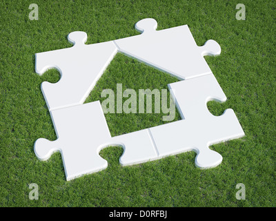 Puzzle casa simbolo sull'erba Foto Stock