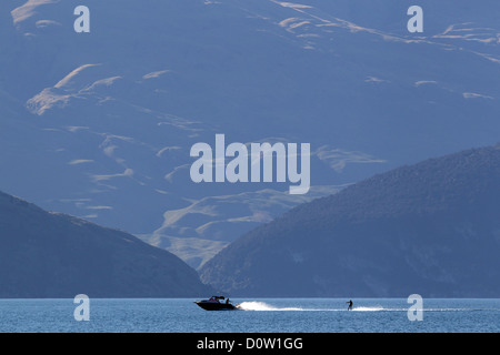 Inizio serata sci d'acqua sul lago Wanaka. Wanaka è un anno meta turistica insieme contro la incontaminata cornice alpina del Monte aspiranti National Park in Central Otago. Isola del Sud, Nuova Zelanda. Foto Stock