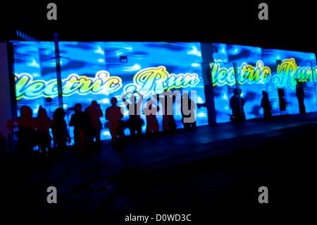 Nov. 30, 2012 - Costa Mesa, California, Stati Uniti - La gente buttare le loro ombre su una parete durante il inauagural corsa elettrico, un tempo di notte, la partecipazione tecnica 5K run.(Immagine di credito: © Brian Cahn/ZUMAPRESS.com) Foto Stock