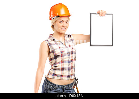 Manuale di Afemale Lavoratore che indossa il casco e tenendo un clipboard isolata contro uno sfondo bianco Foto Stock