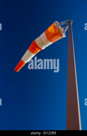 L'immagine verticale di una manica a vento contro la soleggiata cielo blu. Foto Stock