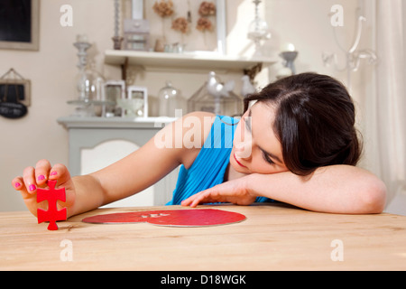 Donna facendo a forma di cuore ad puzzle Foto Stock