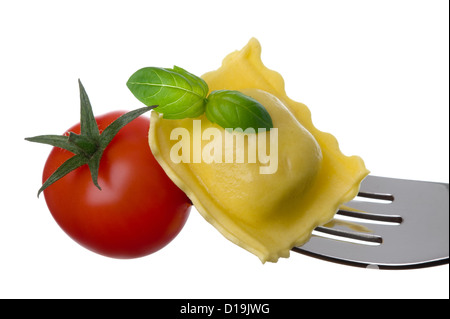 Cucina italiana Cucina o ravioli di pasta di pomodoro e basilico su una forcella contro uno sfondo bianco Foto Stock