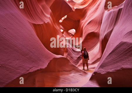 Turista femminile escursionista e arenaria formazioni rocciose, inferiore Antelope Canyon, Pagina, Arizona, Stati Uniti Stati Uniti d'America Foto Stock