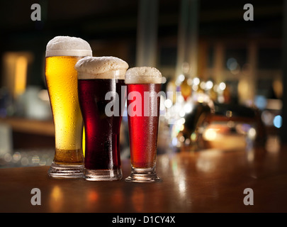 Bicchieri di luce e di birra scura su uno sfondo di pub. Foto Stock