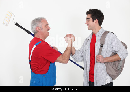 Artigiano e apprendista stringono le mani Foto Stock