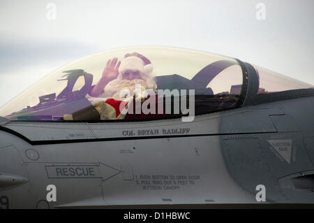 Pilota della US Air Force Col. Bryan Radliff vestiti da Babbo Natale arriva in un F-16 Fighting Falcon per il 419th Fighter Wing festa di Natale 22 dicembre 2012 a Hill Air Force Base, Utah. Foto Stock