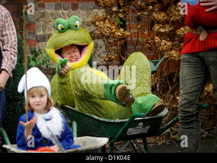 East Hoathly, UK. Il 26 dicembre 2012. East Hoathly Boxing Day pram - GARA - folla rivestita la East Sussex village High Street come team raccolti e fatti correre loro wacky macchine tra i due pub per la carità. Un concorrente si rilassa dopo il trattino in una ruota di Barrow. Credito: Jim Holden / Alamy Live News Foto Stock