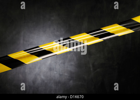 Nero e giallo in plastica del nastro barriera blocca la strada. Foto Stock