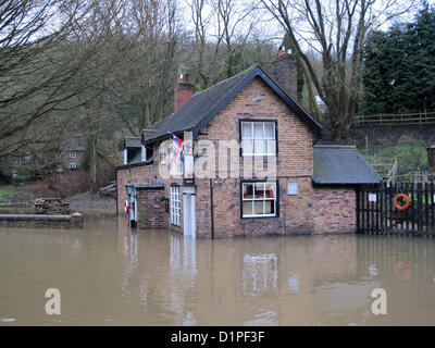 Il 2 gennaio 2013. Inondazioni in Jackfield, Shropshire, Regno Unito. Il memoriale di guerra si siede come un isola con la barca Inn parzialmente sommerso in traboccante acque fangose del fiume Severn. Foto Stock