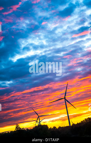 Una silhouette di windturbines su un tramonto da favola Foto Stock