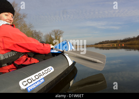 Giovane donna in Colorado Sevylor Premium canoa gonfiabile sul fiume Bure vicino Horning, Norfolk Broads National Park Foto Stock