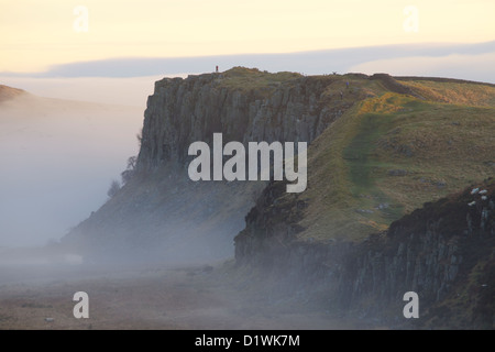 Highshield balze e roccioso del Lough nella nebbia da acciaio Rigg, il vallo di Adriano. Northumbria, (Northumberland), Inghilterra Foto Stock