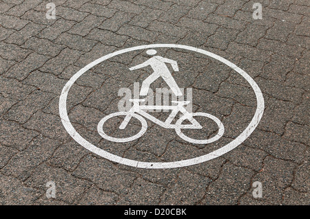 Un dipinto di segno grafico consente di ciclisti e pedoni sanno che la passerella che stanno usando è uno spazio condiviso. Foto Stock