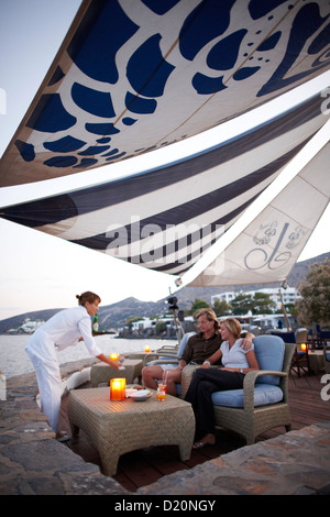 Matura in un bar sulla spiaggia la sera, Elounda, Agios Nikolaos, Creta, Grecia Foto Stock