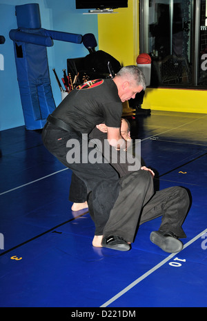 Hapkido cintura nera combattenti praticare la loro arte in una scuola di arti marziali. Foto Stock