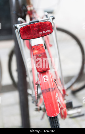 Parigi, Francia: Vecchia dipinta di rosso parcheggiato in bicicletta sulla strada Foto Stock