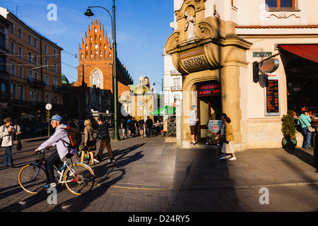 La gente a piedi e in bicicletta in Grodzka Street, citta' vecchia di Cracovia, in Polonia Foto Stock