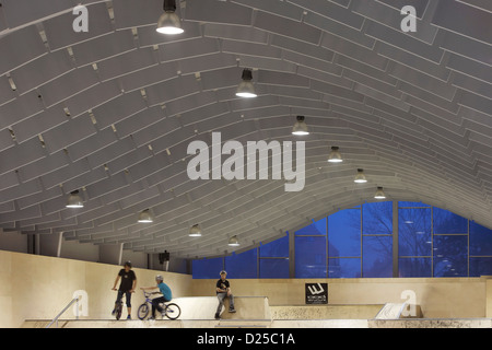Zap" Ados Skatepark, Calais, Francia. Architetto: Bang Architectes, 2011. Vista del soffitto di deflettori e funbox al crepuscolo. Foto Stock