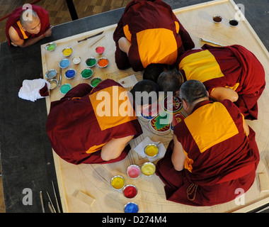 Monaci provenienti dall'esilio chiostro 'Sera Jhe' in India del Sud opera su un misuratore di tre grandi mandala di sabbia presso il Museo Etnologico di Amburgo, Germania, 15 gennaio 2013. Essa dovrebbe essere terminato il 20 gennaio 2013 e distrutta con la sabbia è disseminata nel Lago Alster come un simbolo della natura transitoria della vita materiale. Foto: ANGELIKA WARMUTH Foto Stock