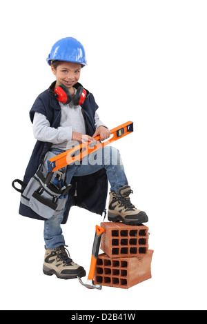 Piccola ragazza fingendo di essere lavoratore edile Foto Stock