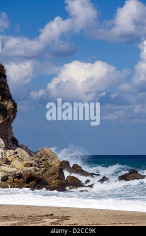 Onde che si infrangono sulla spiaggia rocciosa Foto Stock