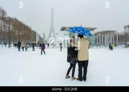 Parigi, Francia, coppia in piedi dal retro, osservando una grande folla di persone che si divertono con le scene invernali della neve, la Torre Eiffel, gli Champs de Mars, il parco giochi urbano, il giardino, persone in tempesta di neve Foto Stock