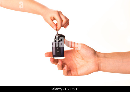 Maschio lato tenendo premuto un tasto auto e consegnarlo a un'altra persona isolata Foto Stock